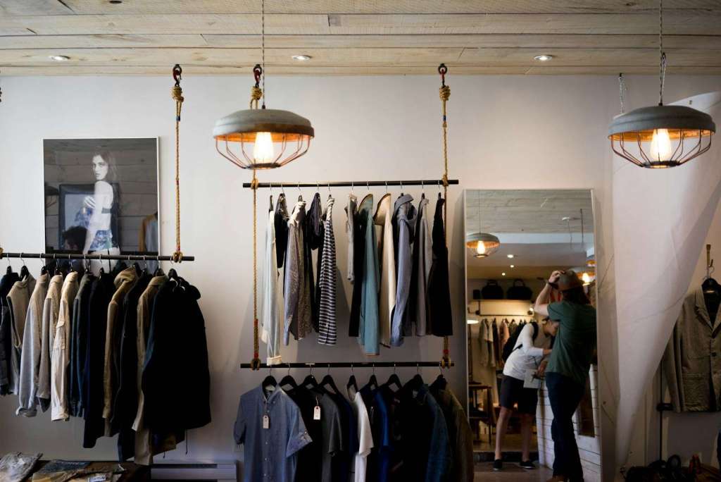 clothing boutique interior with hanging racks