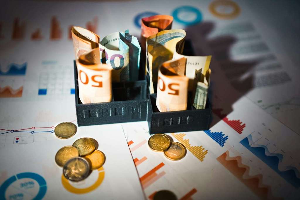 A pile of money sitting on top of a table